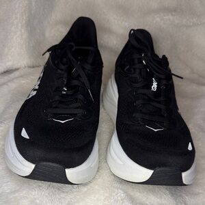 Hoka Black and White Running Shoes ,minor damage on the heals of the shoe.